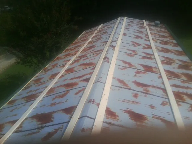 Rusted metal roof panels with new wood purlins before replacement — Storm Damage Roof Repair in Perkasie by Roofing Brothers